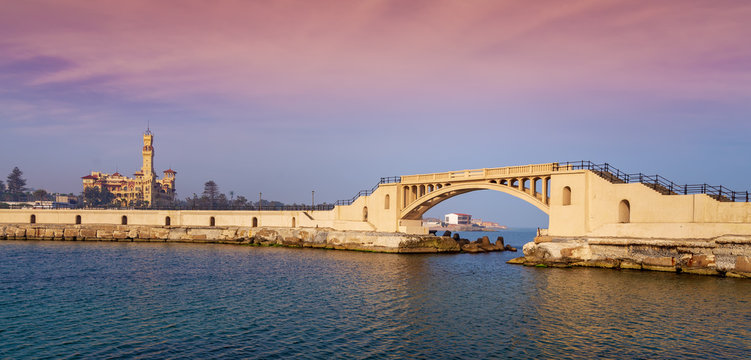 Bridge in the sea at Montazah park with the Royal palace in the far distance with calm sea at sunrise time, Alexandria, Egypt