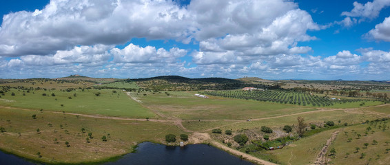 Fototapeta na wymiar aerial view over the agricultural fields with a lagoon in Alentejo Portugal