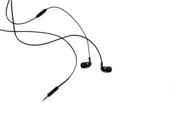 Black headphones for listening to music and sound on portable devices: music player, smartphone, laptop and jack for connection on a white background. Ear plugs.