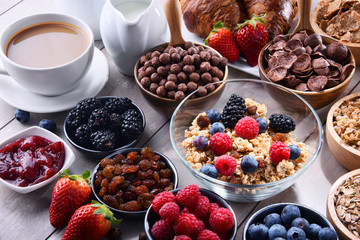 Different sorts of breakfast cereal products and fresh fruits