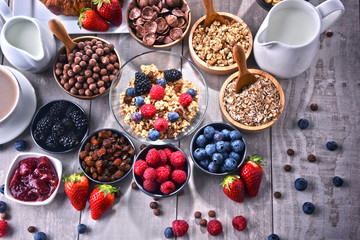 Different sorts of breakfast cereal products and fresh fruits