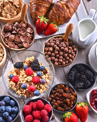 Different sorts of breakfast cereal products and fresh fruits