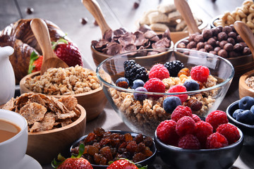 Different sorts of breakfast cereal products and fresh fruits