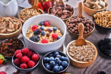 Different sorts of breakfast cereal products and fresh fruits