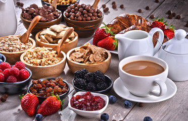 Different sorts of breakfast cereal products and fresh fruits