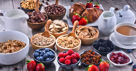Different sorts of breakfast cereal products and fresh fruits