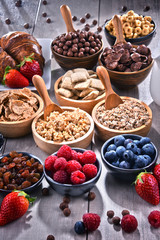 Different sorts of breakfast cereal products and fresh fruits