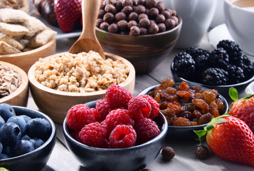 Different sorts of breakfast cereal products and fresh fruits