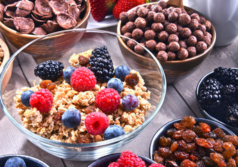 Different sorts of breakfast cereal products and fresh fruits