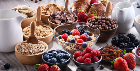 Different sorts of breakfast cereal products and fresh fruits
