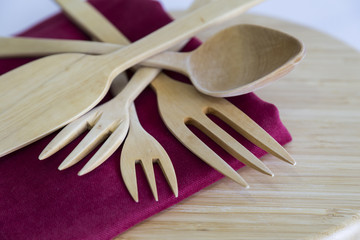 wooden handmade fork,spoon and spatula on the red service napkin for kitchenware concept.
