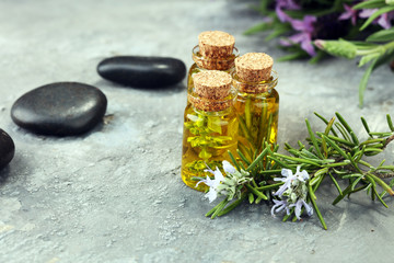lavender oil in a glass bottle on a background of fresh flowers.