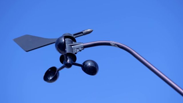 An anemometer spins on a wind. Special anemometer spins and stops on a wind outdoors.