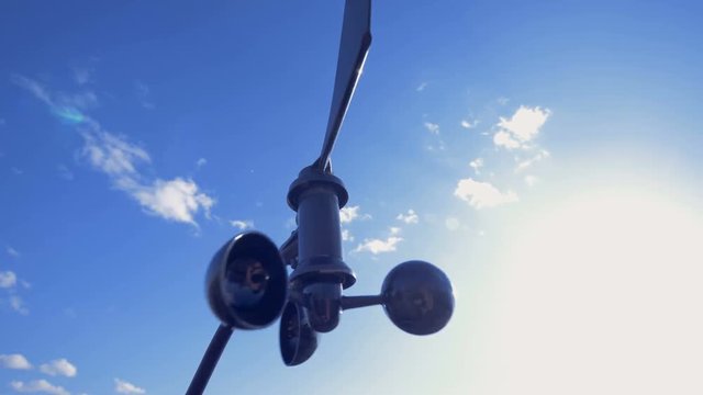 An anemometer turns, working outdoors.