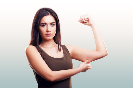 Woman Pinching Flabby Fat Arm Skin