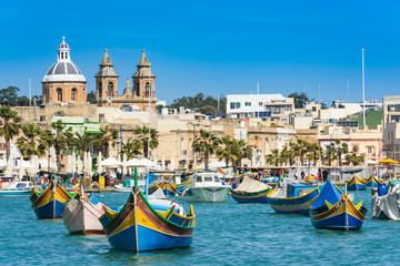 Fototapeta na wymiar Vibrant fiherman boats in Malta