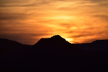 Sun sets behind the mountains in Sedona, AZ