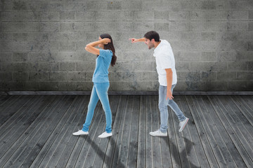 Obraz na płótnie Canvas Angry boyfriend shouting at girlfriend against grey room