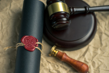 Last will and testament on yellowish paper with wooden judge gavel document is mock-up