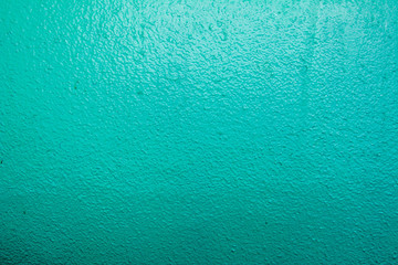 Wall painted in blue texture. Seamless texture of a light pale green concrete wall. Abstract background.