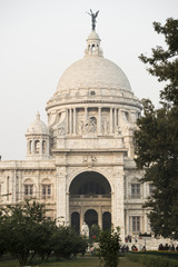 Fototapeta na wymiar The landmark Victoria Memorial is a large marble building in Kolkata, West Bengal, India. It is dedicated to the memory of Queen Victoria.