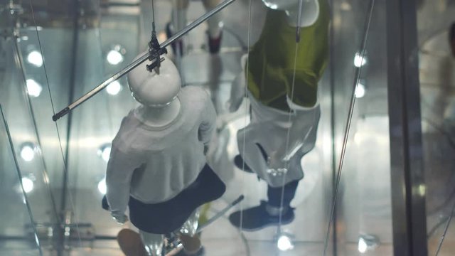 View through window to modern concept manikins at the store.