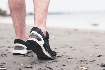 Naklejka premium Man healthy jogging at the beach. Concept to life and health.