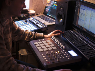 sound egineer man with long hair sitting in the studio