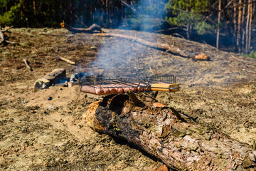 Raw sausages in a barbecue grill before cooking