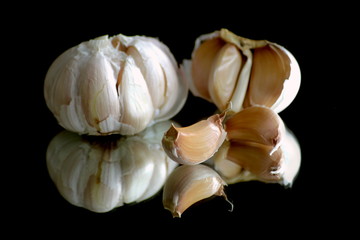 Garlic on a black reflective background