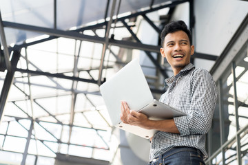 close up engineering man holding laptop and standing over building site for checking  quality