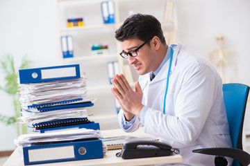 Busy doctor with too much work in hospital