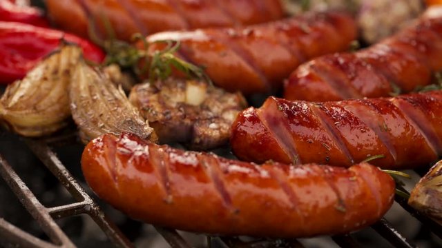 Grilled sausages and vegetables on a grilled plate, outdoor. Grilled food, bbq, 4K