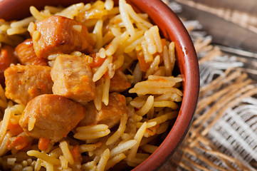 Food - fried pieces of turkey poultry meat with rice, onions, carrots and seasonings.