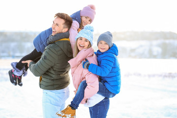 Happy family having fun outdoors on winter day