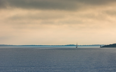 Fototapeta na wymiar Lonely sailing ship at the horizon
