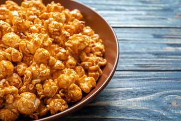 Delicious popcorn with caramel on plate