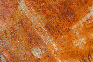painted iron surface with a large rusty and metal corrosion, old background with peeling and cracking paint as background, orange texture