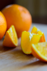 Oranges cut and set on wooden cutting board