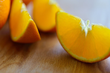 Oranges cut and set on wooden cutting board