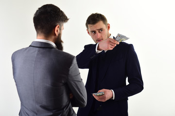 Businessmen, business partners counting profit. Meeting of reputable businessmen, white background. Man in suit on serious face counting money, pay to partner. Business payment concept.