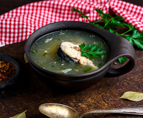 Boiled fish soup with mackerel in a brown clay plate