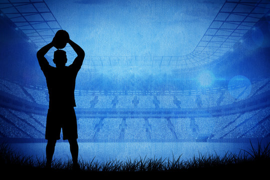 Silhouette of rugby player against rugby stadium - Powered by Adobe