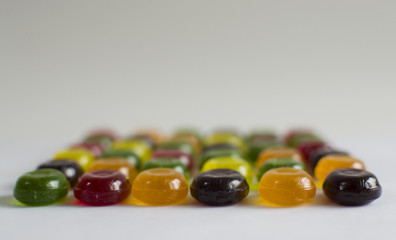 line of colored caramel on a white background horizontal