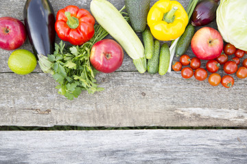 Set of raw organic fruits and vegetables on dark wooden background. Copy space. Top view. From above.