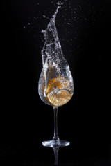 orange drop into water in glass