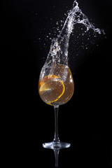 orange drop into water in glass