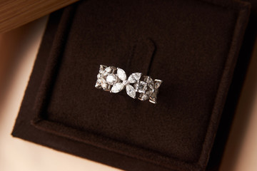 Wedding diamond ring with gift box, close-up. Luxury female jewellery, selective focus