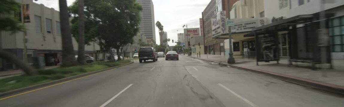 Front view of a Driving Plate: Car travels on Wilshire Boulevard from Dunsmuir Avenue to Fairfax Avenue in Los Angeles, California.