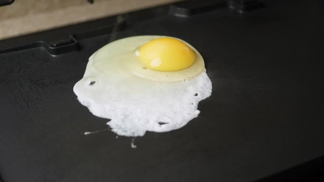 Crack eggs on electric barbecue